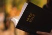 Christian teen girl holds bible in her hands. Reading the Holy Bible. Concept for faith